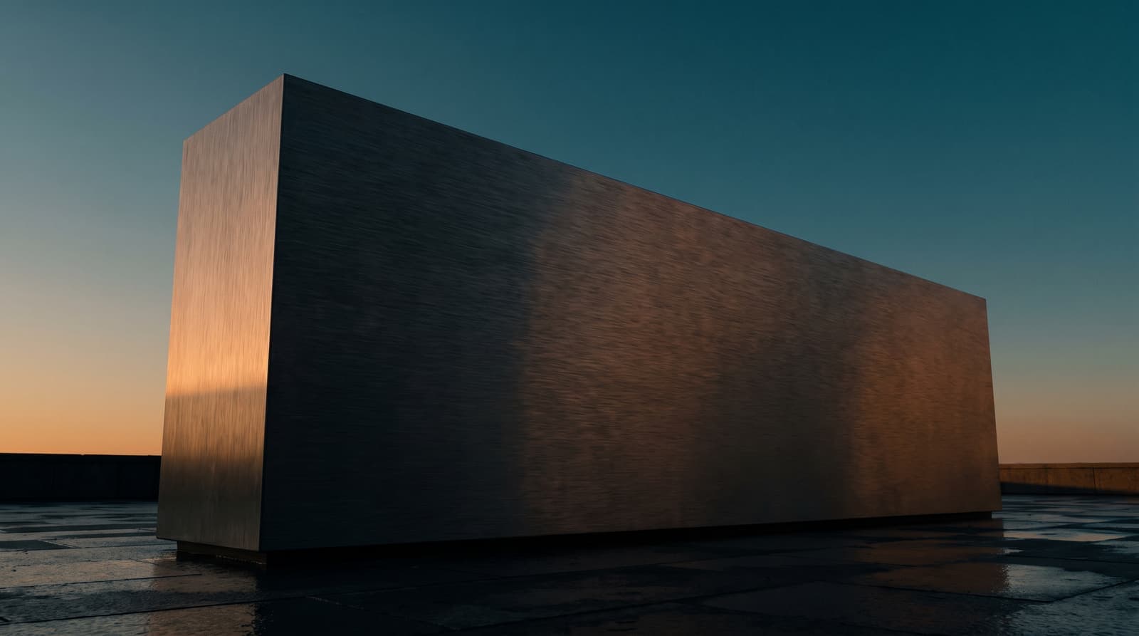 A brushed-steel corporate nameplate at dawn
