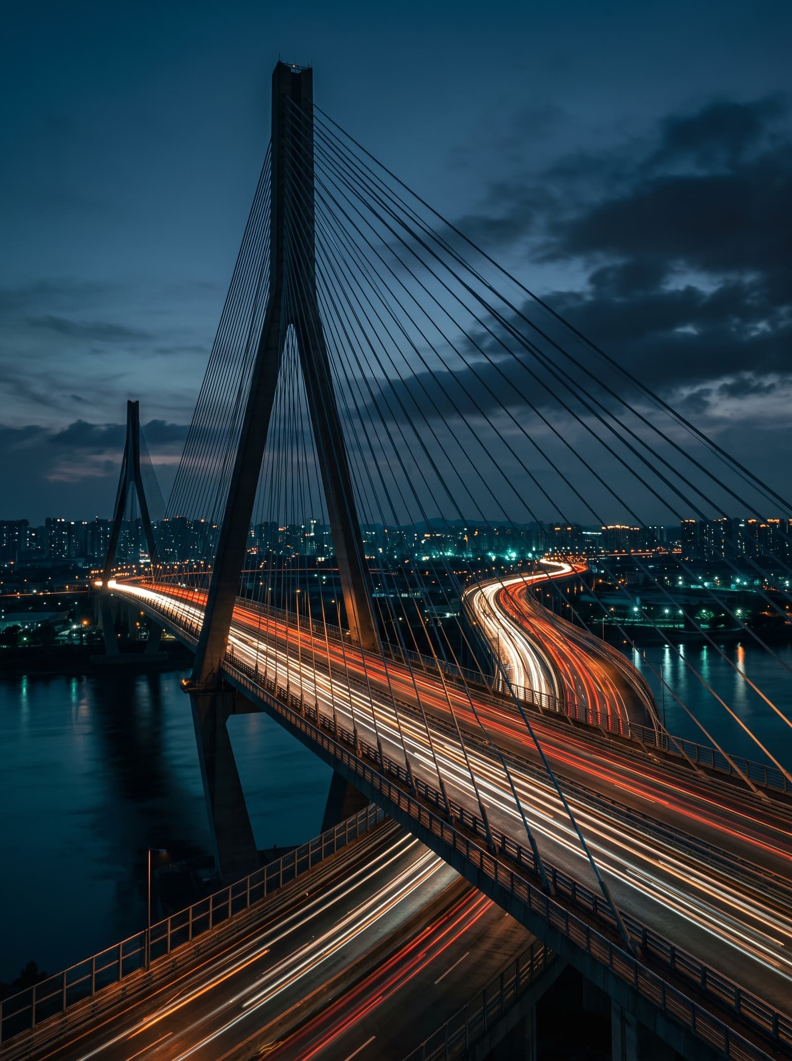A cable-stayed bridge with light trails at blue hour